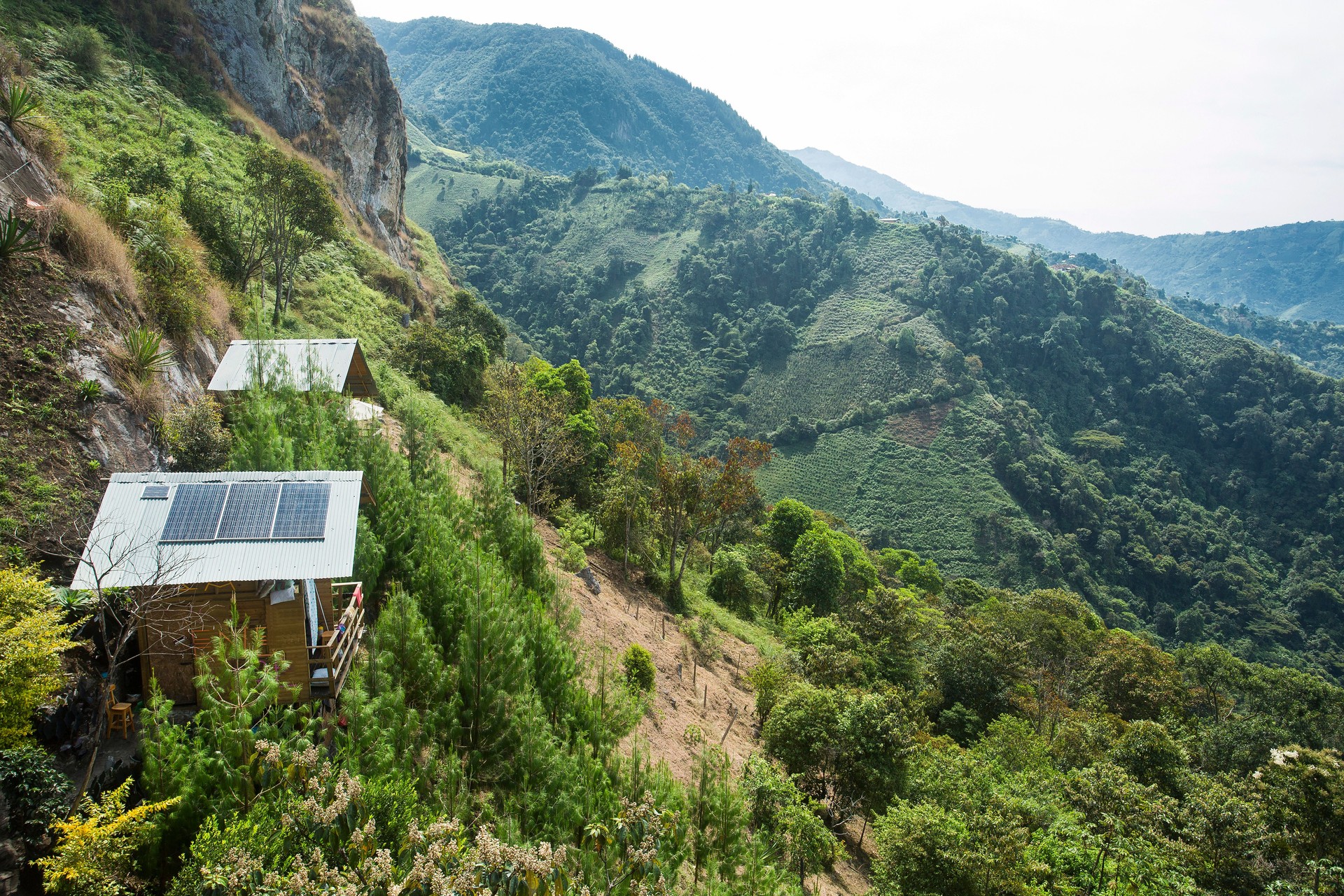 Traditional wooden house with solar panels in the mountains of Colombia